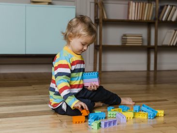 portrait-little-boy-playing-with-toys