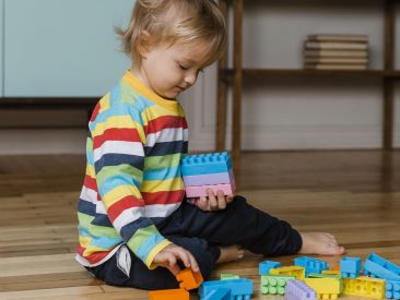 portrait-little-boy-playing-with-toys